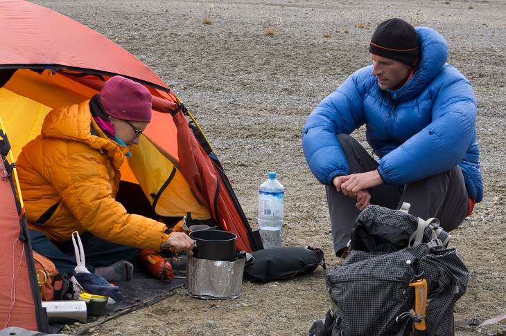 Mountain climbers at Base Camp making food with camping stove in the Andes of Peru