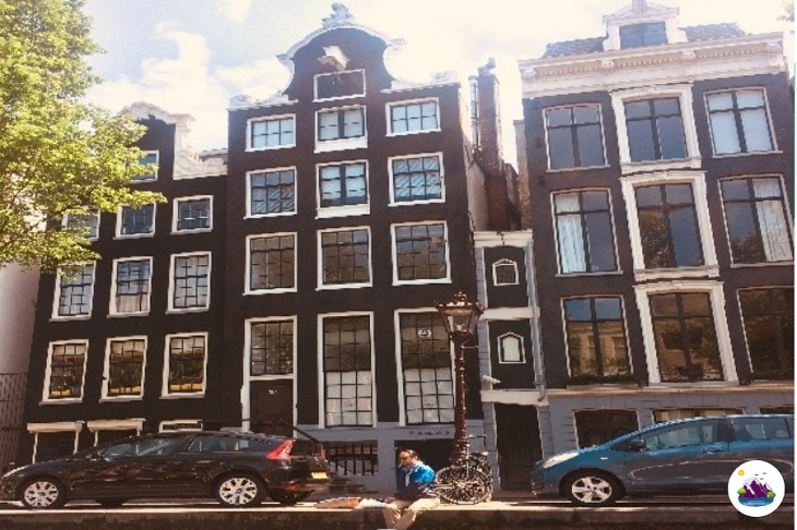 things to do in amsterdam marvel at narrow houses photo by Sally