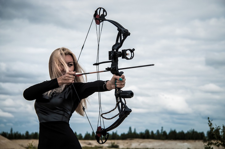 Types of bows for hunting and archery - Young woman with a compound bow