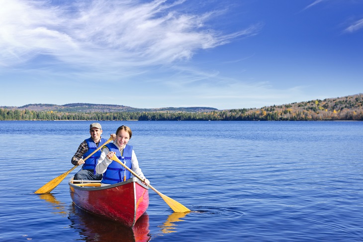 Father and daughter canoeing on Lake of Two Rivers, Ontario, Canada