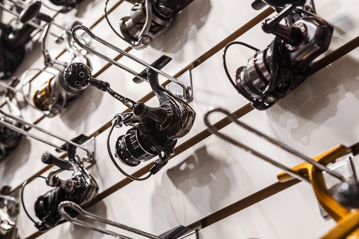 Different fishing reels in the window of a fishing store